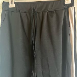 Medium black tracksuit pants, never worn, drawstring waist, white + red stripe